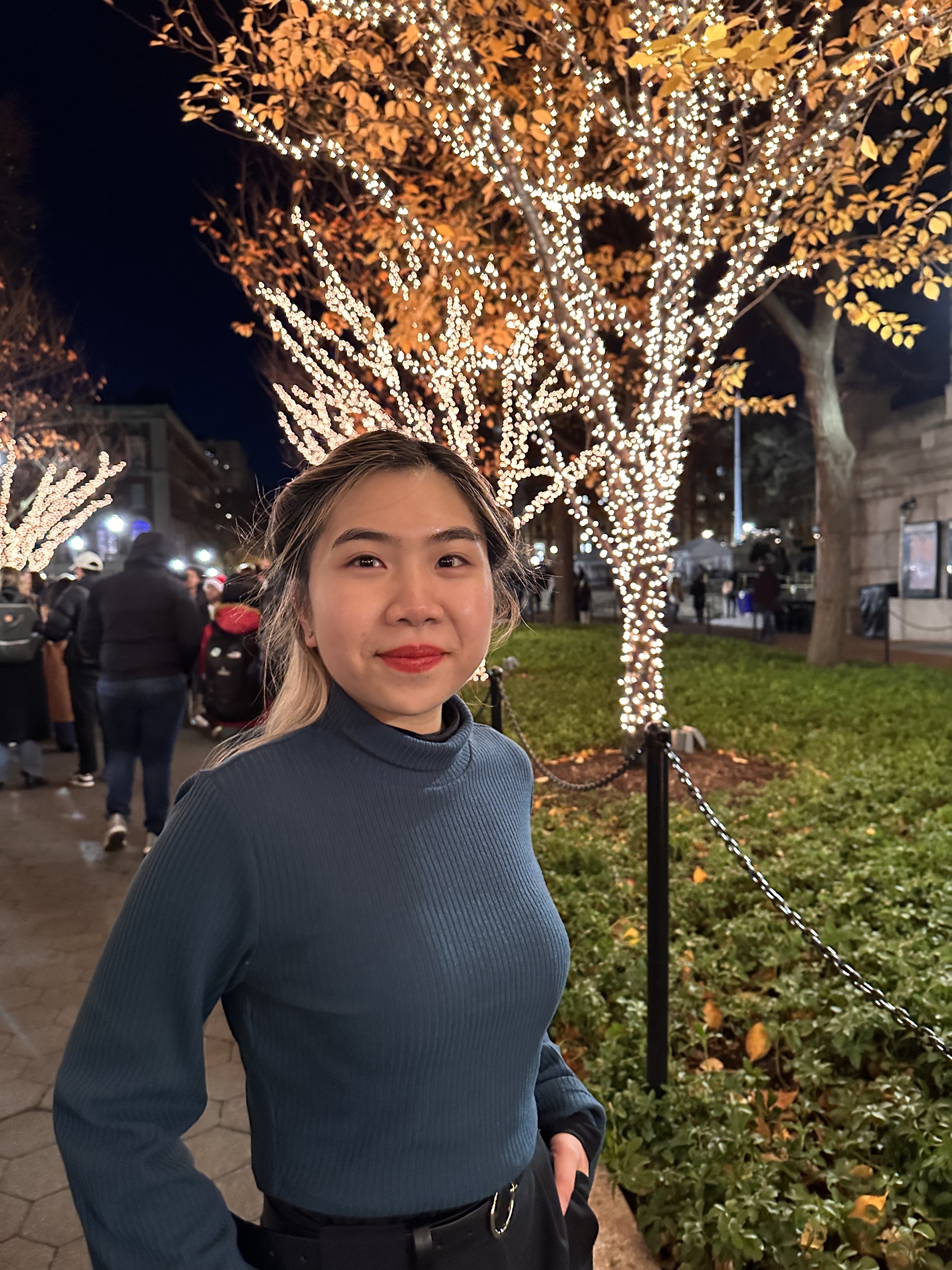 Portrait of Amy Zhang smiling on college walk.