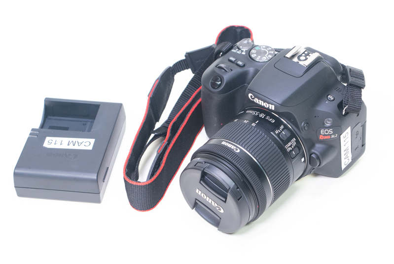 A Canon EOS Rebel SL2 with battery charger