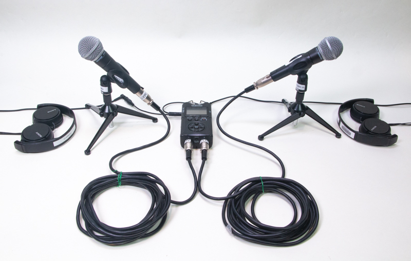 A pair of Shure microphones, a Tascam recorder, wires, and a pair of Sony headphones